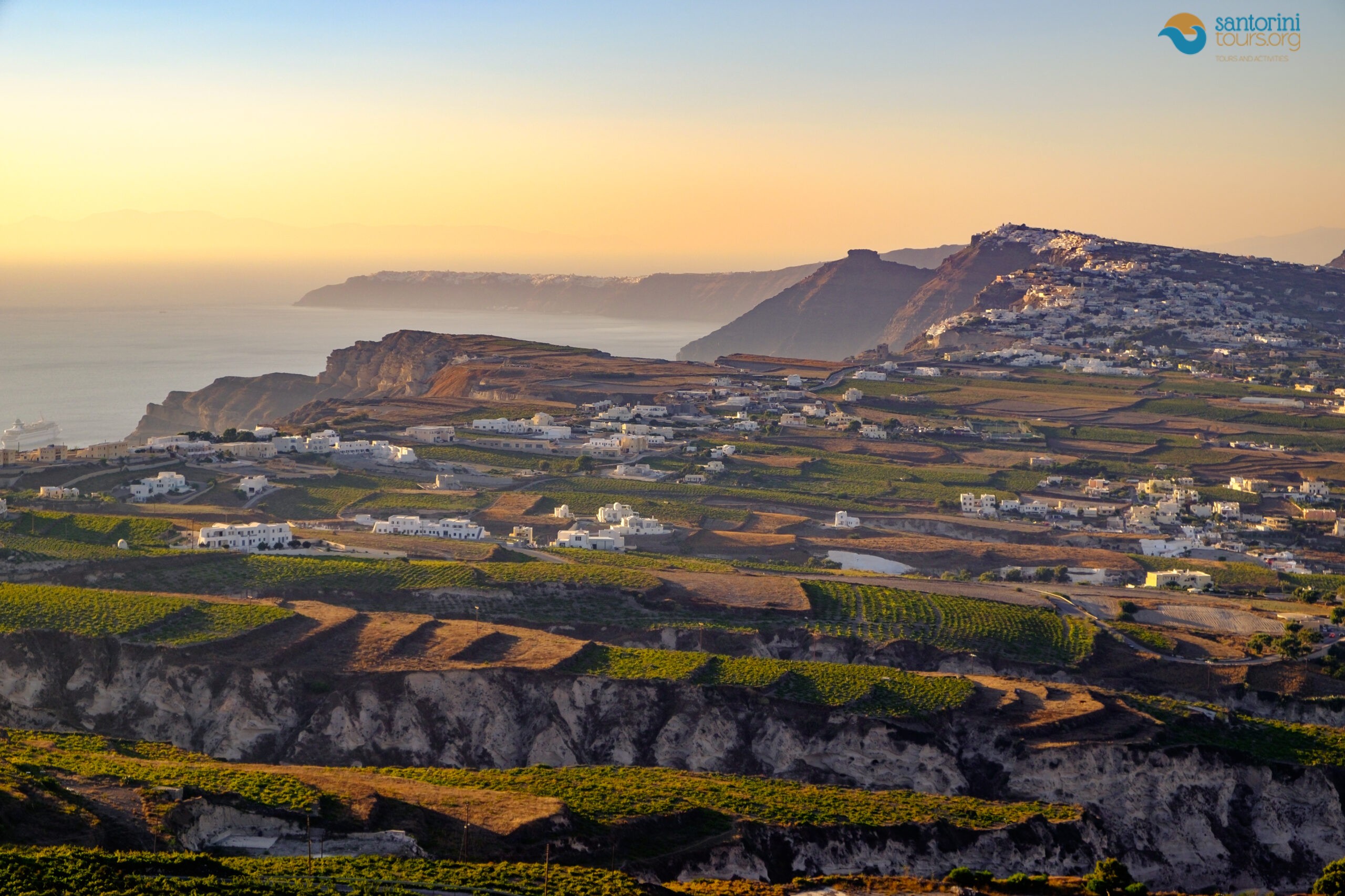 the vineyard plain and Pyrgos, empty when the rim is busy in June