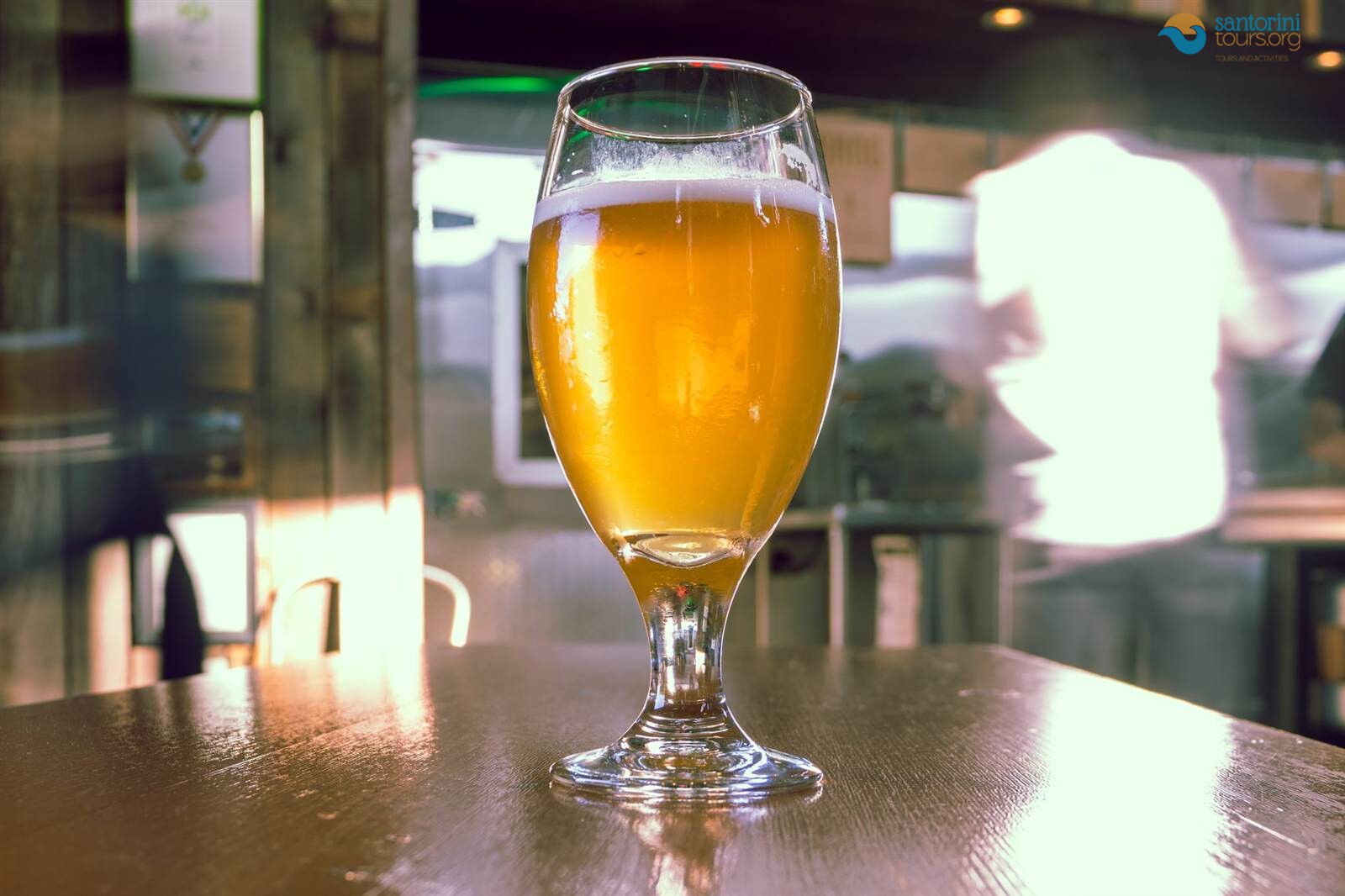 a glass of craft beer in a santorini brewery taproom