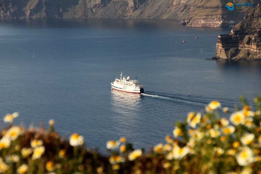 a boat inside the caldera on a santorini catamaran cruise route