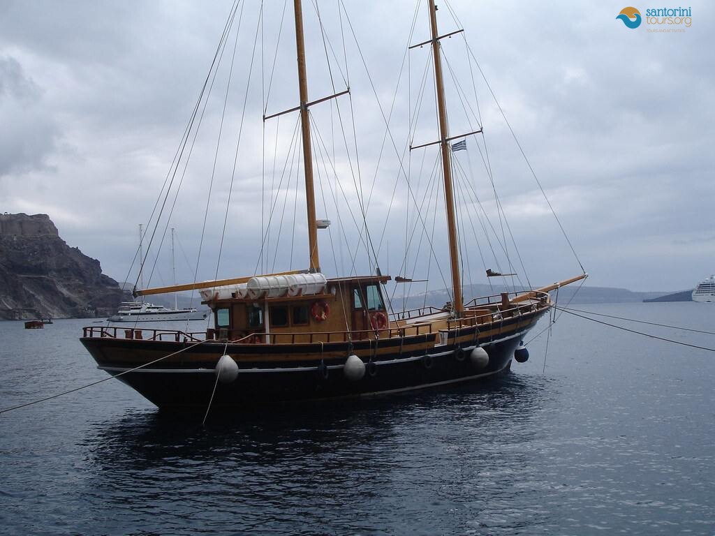 a traditional wooden kaiki used for a santorini fishing trip