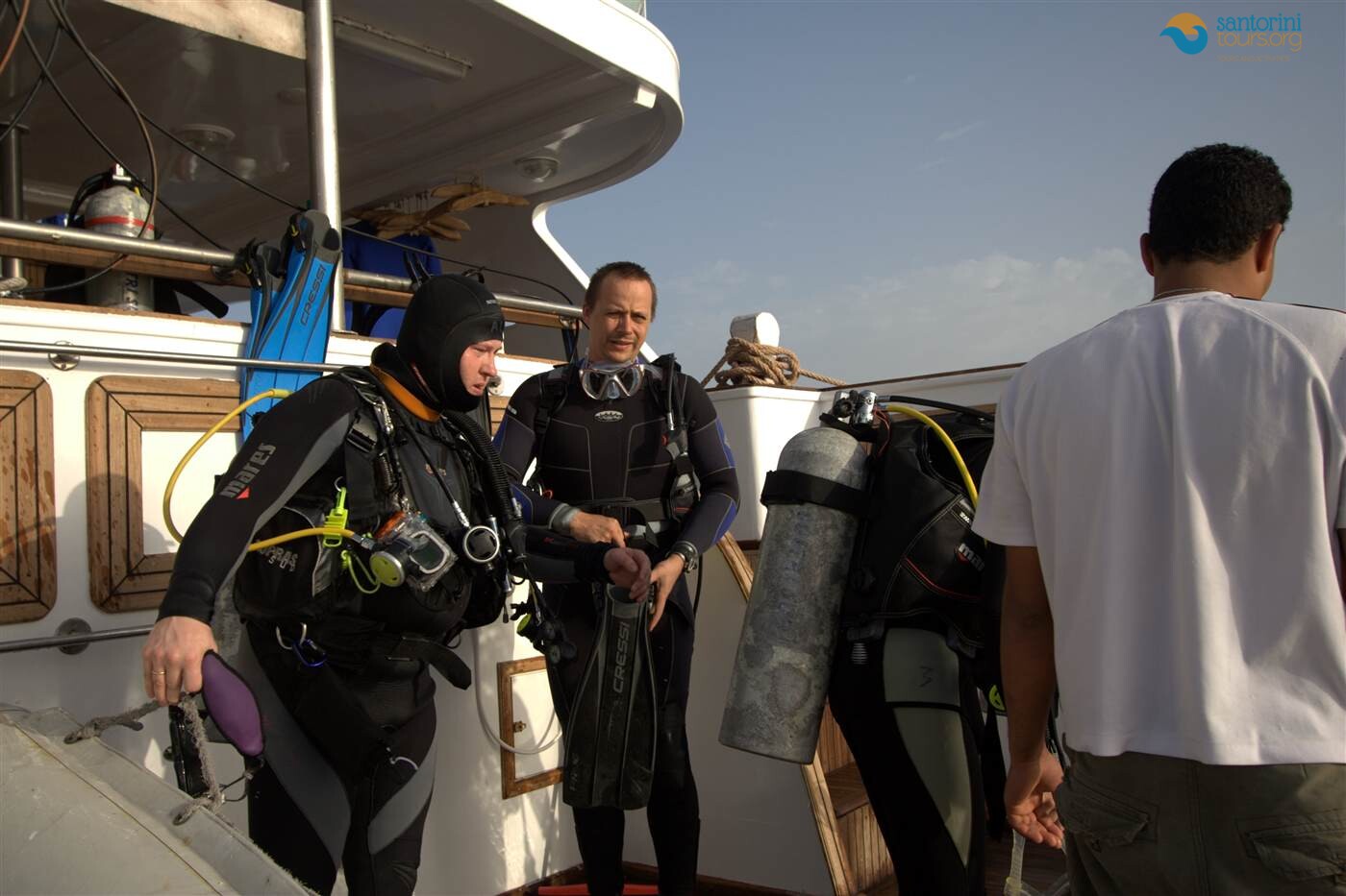 divers kitting up on the boat before santorini scuba diving