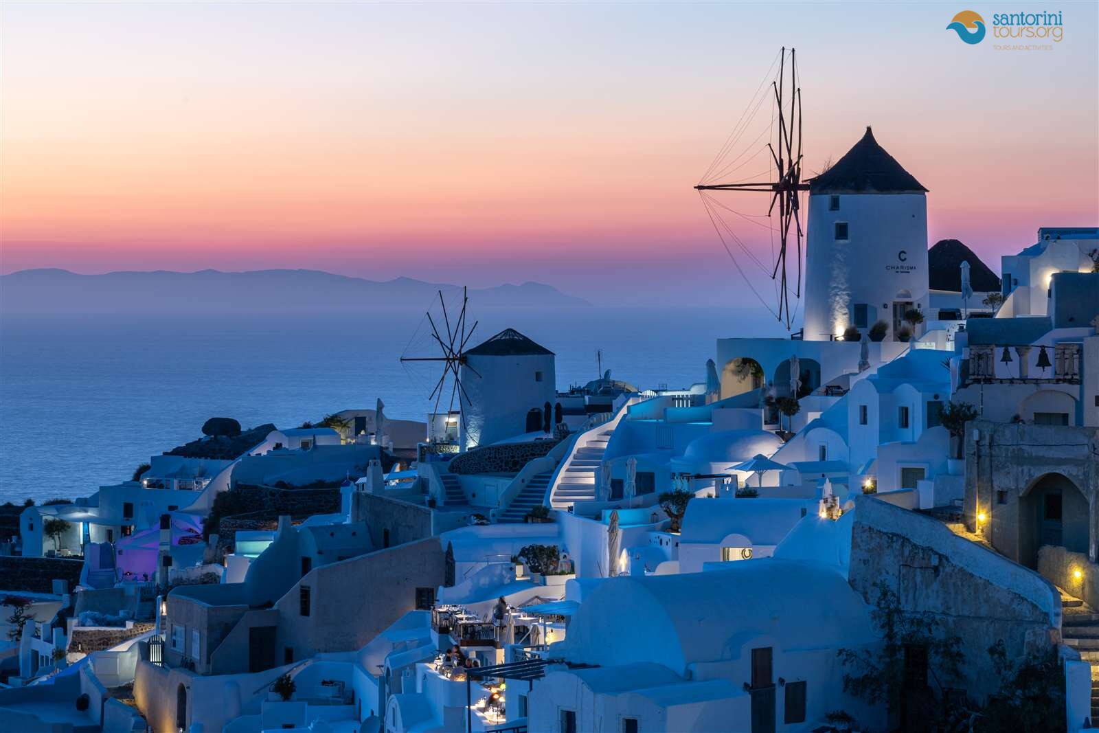 the two santorini windmills at Oia at blue hour